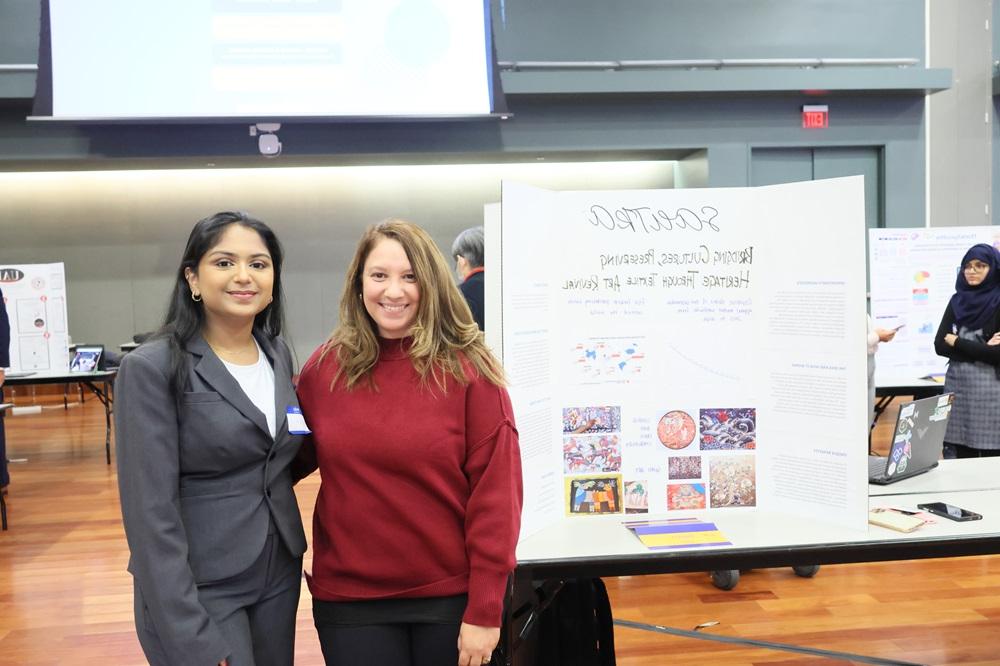 SAS student presenting at SVIC 2024 and posing for a picture with her SAS Program Manager 